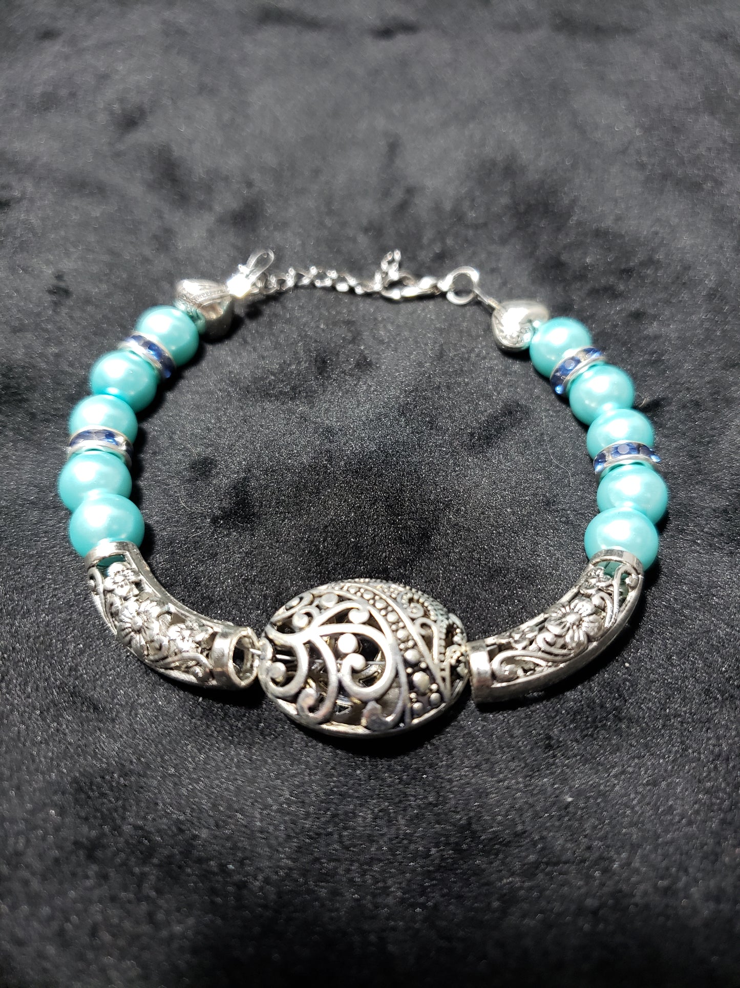 Bracelet with blue beads and silver clasp on a dark background