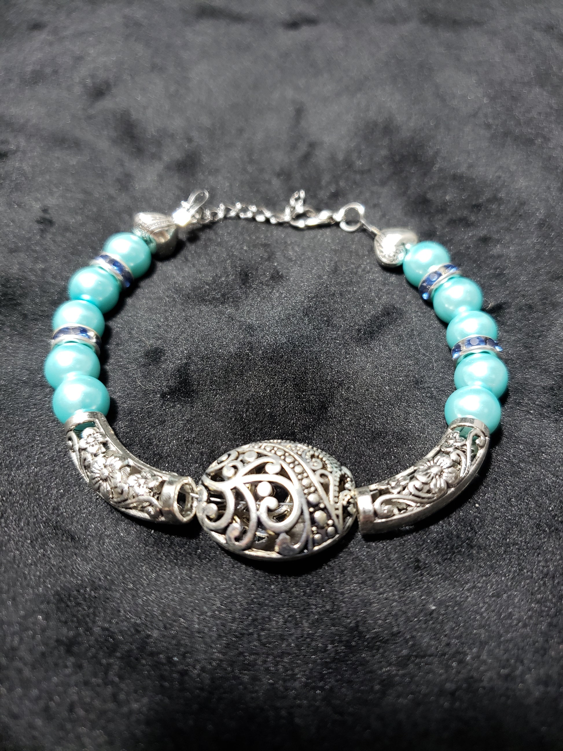 Bracelet with blue beads and silver clasp on a dark background