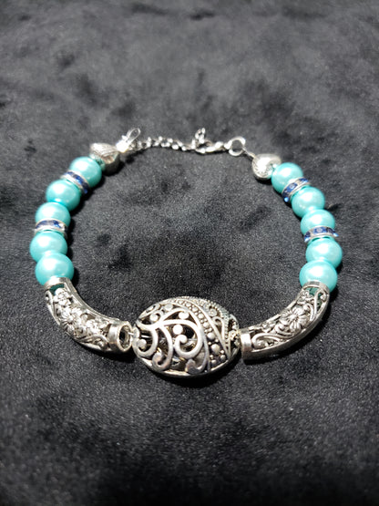 Bracelet with blue beads and silver clasp on a dark background